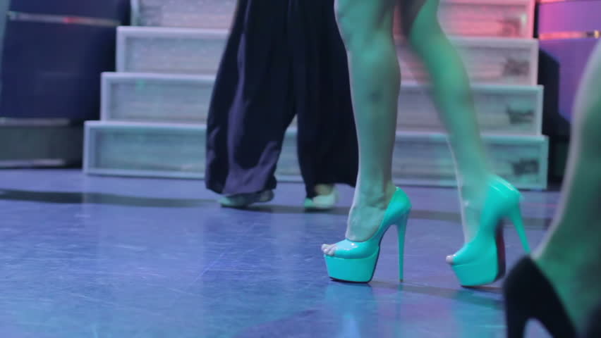 Young female in kitchy shoes dancing disco style at party