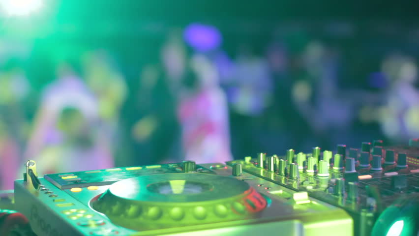 DJ hands in strobe lights at elite party in best nightclub
