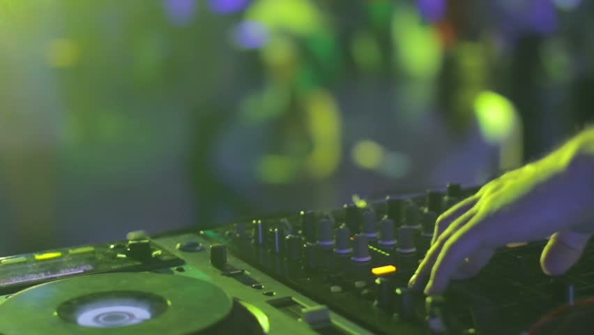 Tweaking controls hands of sound engineer make people dance to music