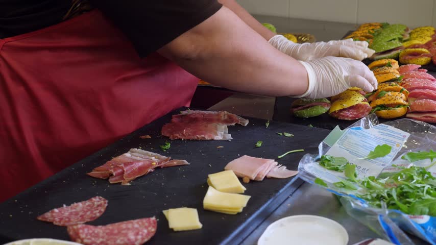 In the kitchen, sandwiches are being prepared for the children