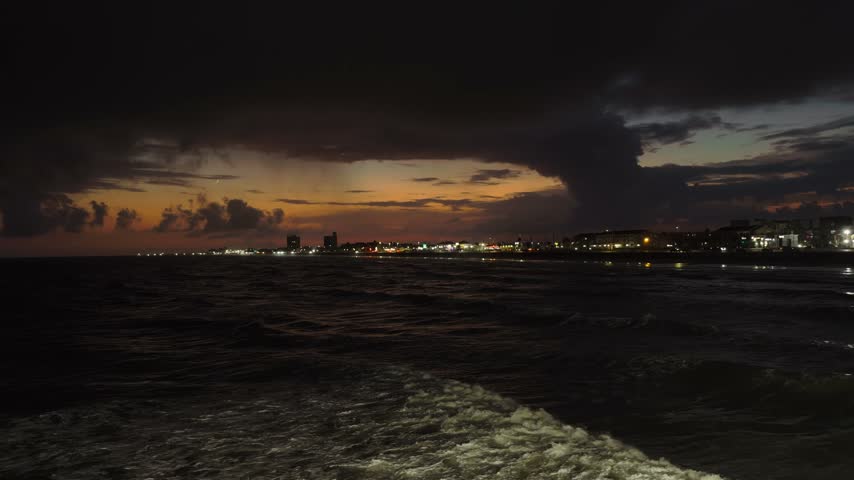 A shot of Galveston Island shore line after sunset from the 61st street pier in Galveston, Texas.
