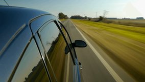 Driving a black car POV. Right side reference. Country road, trees on the side, fall, day. Fast Speed / time-lapse. HD.