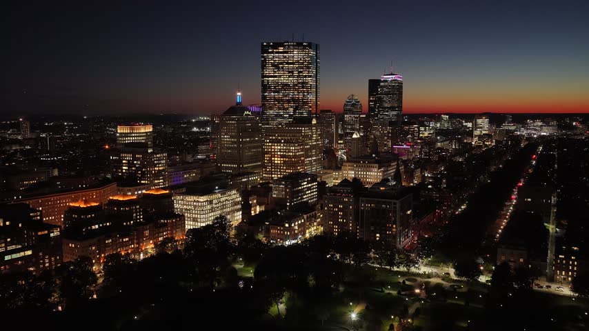 Sunset Over Boston Skyline In Massachusetts United States. Illuminated Cityscape. Downtown District. Highrise Buildings. Boston Skyline In Massachusetts United States. Sunset Skyline.