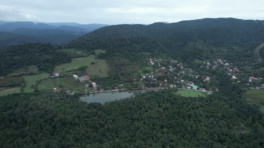 Lakeside Village Beneath Forested Hills