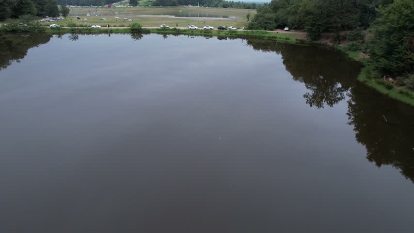 Lake Shore with Road and Vehicles Along the Bank