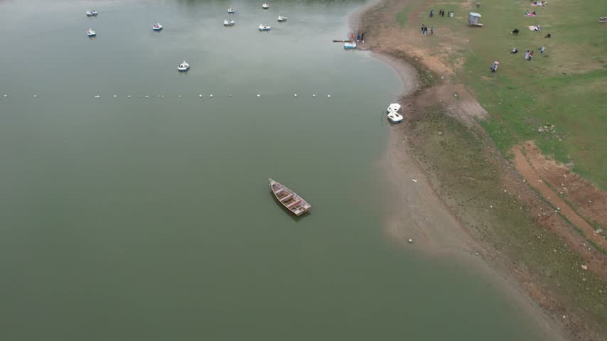 Small Boat on a Lake Near a Sandy Shore