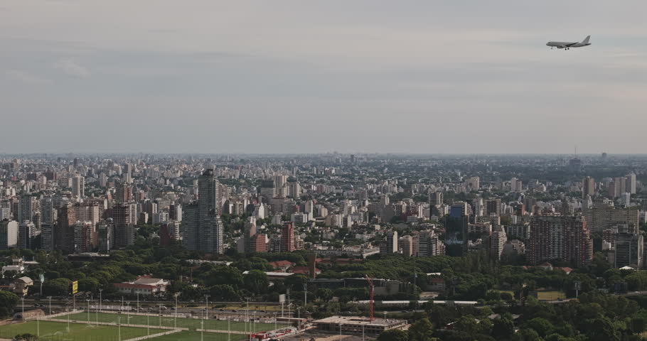 Buenos Aires Argentina Aerial v128 zoomed telephoto pan across Nunez marina, Estadio Monumental and the Rio de la Plata with an airplane overhead - Shot with 5k Camera - Jan 24th 2026