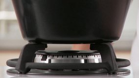 A gas hob being turned on