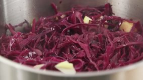 Red cabbage with apples being braised