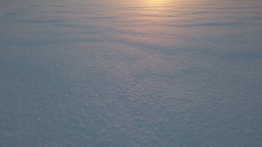 Sparkling snow at sunset close up
