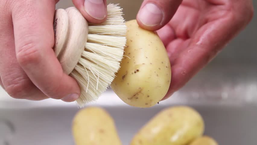Potatoes being washed under running water