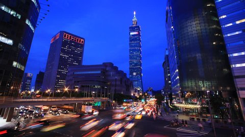 TAIPEI, TAIWAN - CIRCA JULY 2013: (Timelapse View) By the corner of busy Taipei street after working hours with Taipei 101 at back, circa JULY 2013 in Taipei, Taiwan.