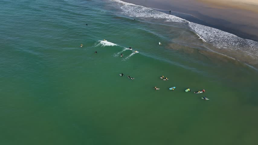 Surfers on small wave, arial view
