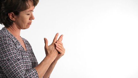 A woman who is experiencing arthritic pain in her fingers.