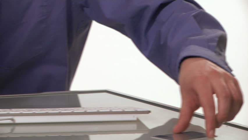 young professional man enters credit card information on a desktop computer