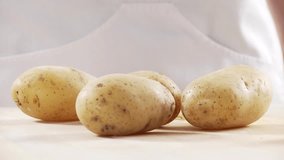 Cooked potatoes being peeled