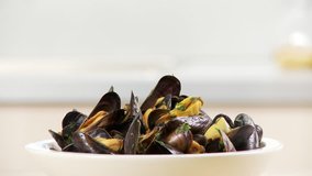 Mussels in a white wine and tomato broth being served
