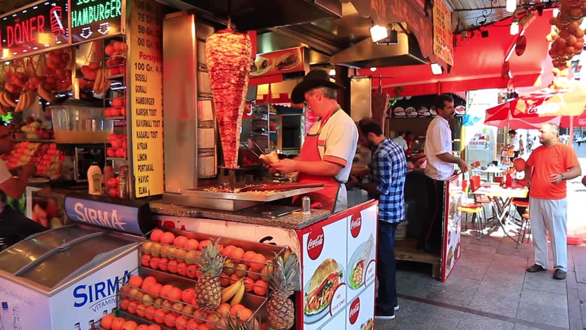 ISTANBUL - JUL 3: Man cooks and sells doner kebab in a small buffet at Eminonu