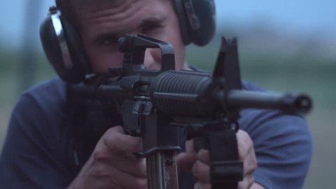 Young man shooting AR15 at range