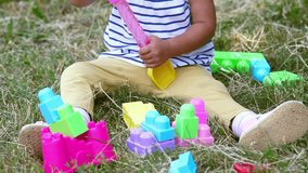 Tilt-up video of a cute baby girl being busy with her development toys