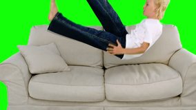 Boy jumping on the sofa on green screen in slow motion - Powered by Shutterstock - Get 15% off with code: PIKWIZARD15