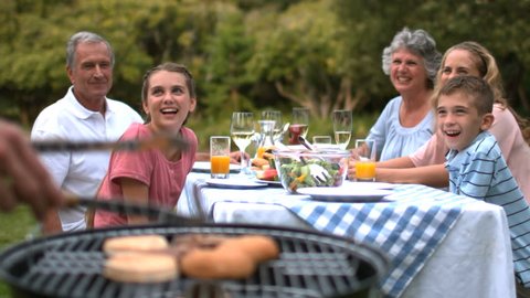 Cheerful family waiting for the barbecue in slow motion