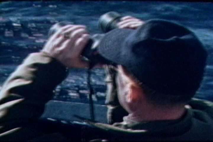 1960s - Naval crewmen man their battle stations after spotting a submarine during the 1960s
