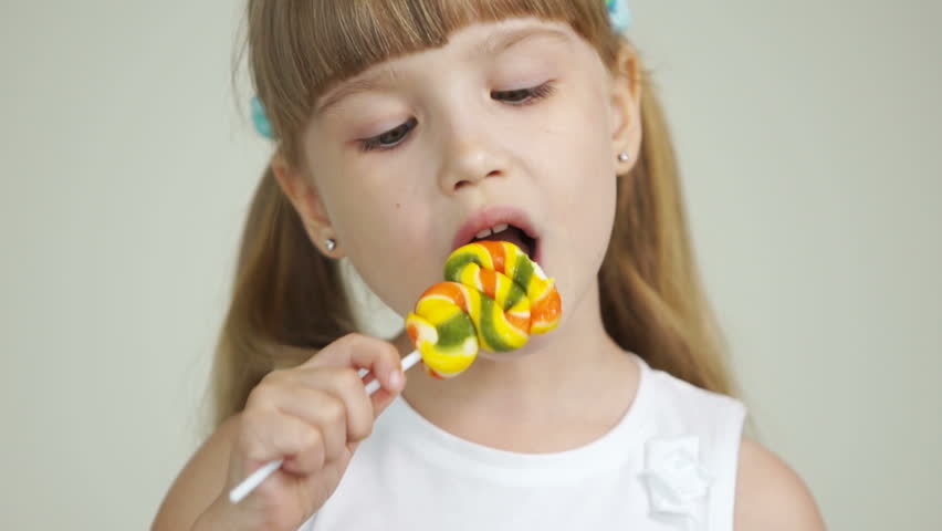 Cute girl chews candy
