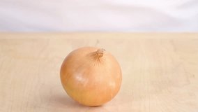 An onion being peeled