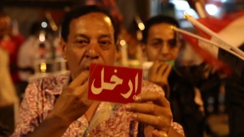 CAIRO, EGYPT - 2013: A protestor blows a whistle at a rally in Cairo, Egypt.