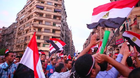 CAIRO, EGYPT - 2013: Protestors chant and wave flags in Cairo, Egypt following the ouster of Morsi.