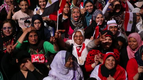 CAIRO, EGYPT - 2013: Protestors chant at a nighttime rally in Tahrir Square in Cairo, Egypt.