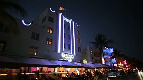 Night P.O.V. driving by illuminated restaurants on Ocean Drive Miami Art deco district of South Beach Florida, USA