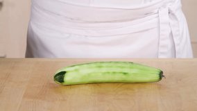 Halving and deseeding a peeled cucumber