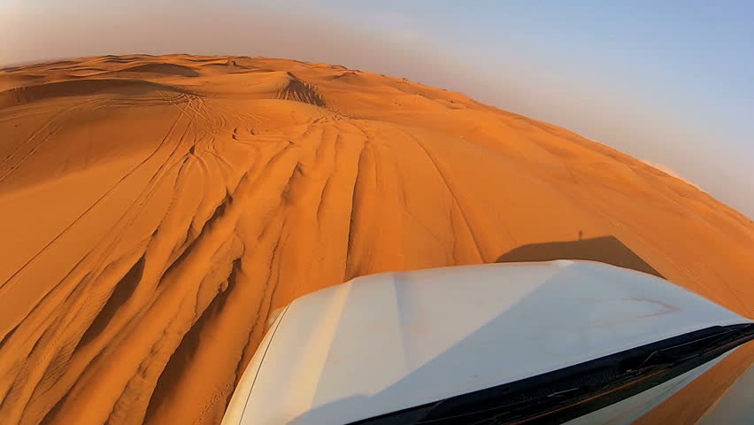 4x4 off road land vehicle taking tourists on desert dune bashing safari, Middle East Royalty-Free Stock Footage #4233490