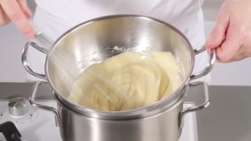 Whisking zabaglione over simmering water until pale and fluffy