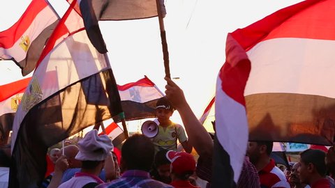 CAIRO, EGYPT - CIRCA JULY 2013: The sun shines through protestor's flags in Cairo, Egypt.