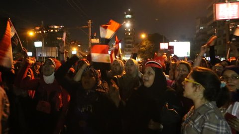 CAIRO, EGYPT - CIRCA JULY 2013: Protestors chant at a nighttime rally in Tahrir Square in Cairo, Egypt following the coup that removed Morsi from office.