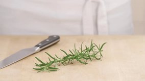 Rosemary needles being removed from a sprig