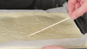 A sponge cake being tested with a wooden stick