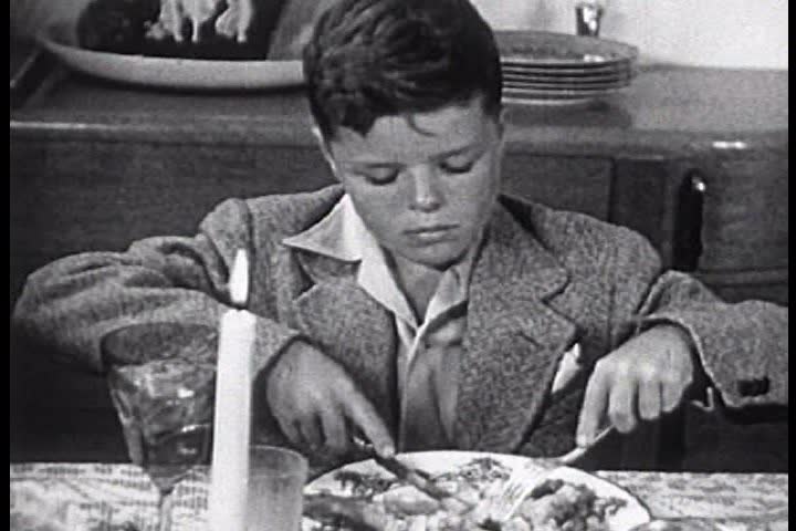 1950s - A family eats their Thanksgiving dinner and begins cleaning up during the 1950s