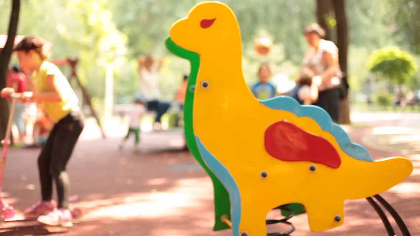 Colorful Dinosaur Toy Against Blurry Stock Footage Video (100% Royalty