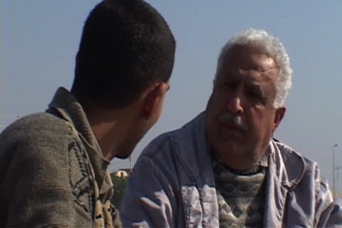 NASIRIYAH, IRAQ - DECEMBER 14, 2003: Two men having a chat.
