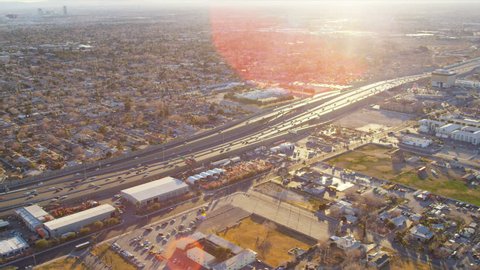 Aerial view of the suburban Freeway traffic commercial business area Las Vegas sun lens flare Nevada, USA