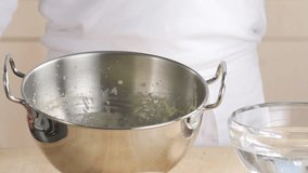 Beating cream in round-bottomed metal mixing bowl