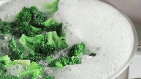 Removing broccoli florets from boiling water with a slotted spoon