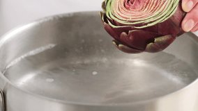 Placing artichokes in boiling water