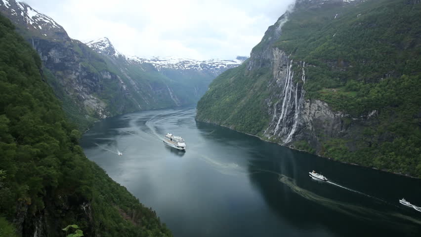 Cruise ship and ferry passes in fjord of Norway