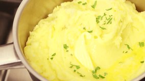 Butter being added to mashed potatoes