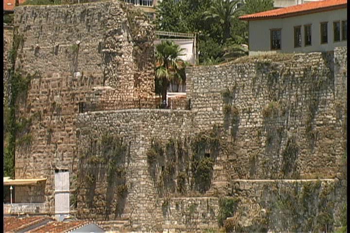2 shots of medieval battlements on the harbor in Antalya, Turkey